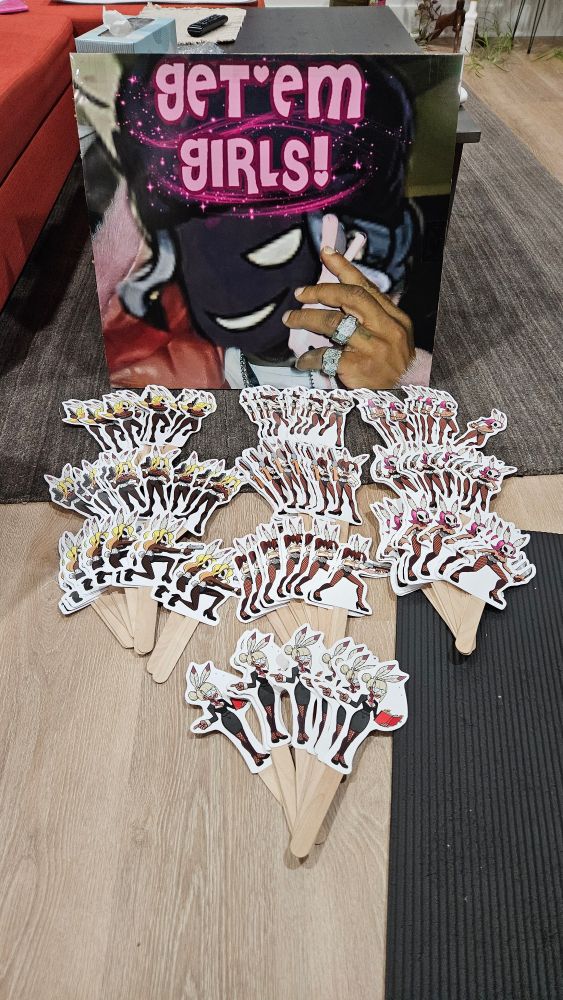 Sign of munozsGETEMGIRLS along with cutouts of Black Dahlia's Bunny Girls from Skullgirls on popsicle sticks