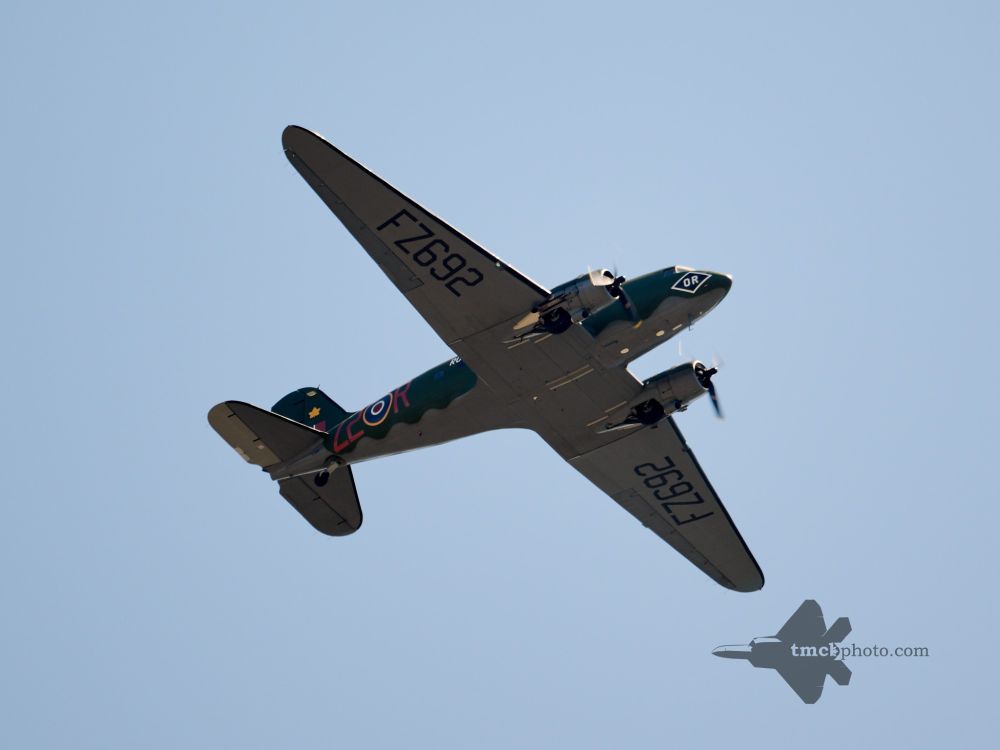 A glimpse of the C-47 Dakota as it passed over Toronto on its way back from CFB Trenton for an 80th anniversary of VE Day event. The sky is clear, and the markings of the plane feature the letters FZ692.