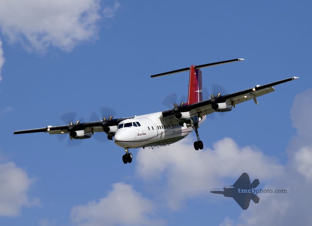Air Tindi Dash 7 on final approach to Downsview Airport on a puffy cloud day.