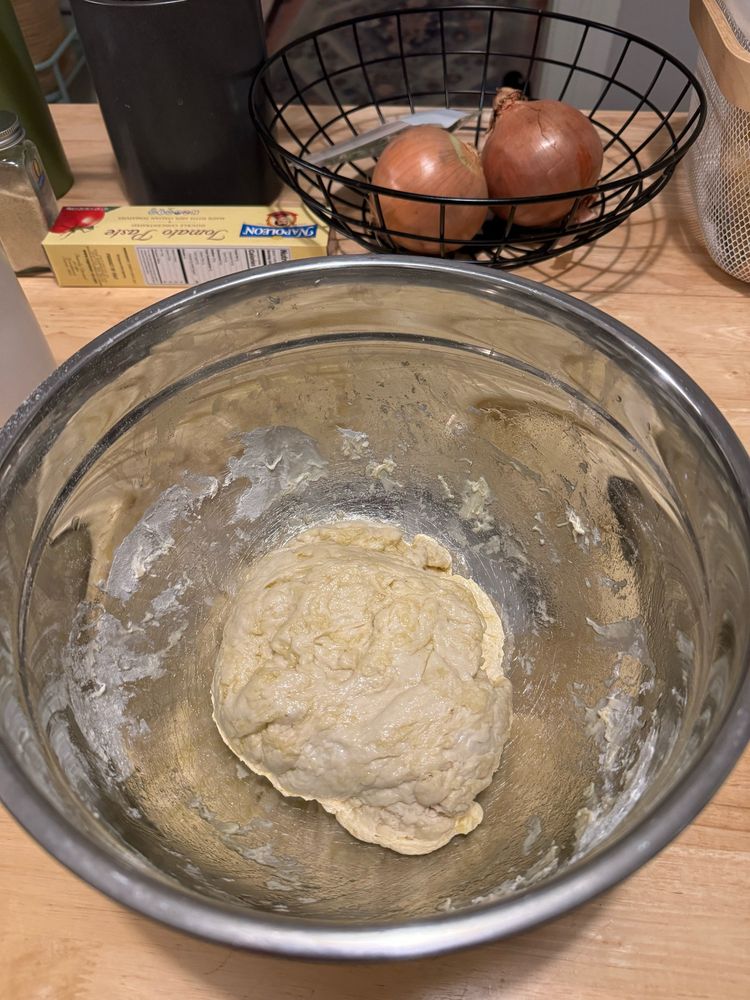Raw dough is seen in a bowl