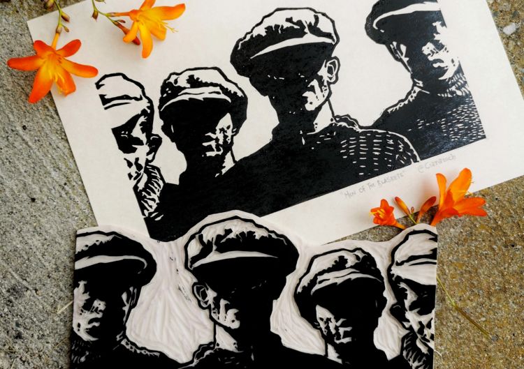Linocut print of Men Of The Blaskets, with small flowers beside it