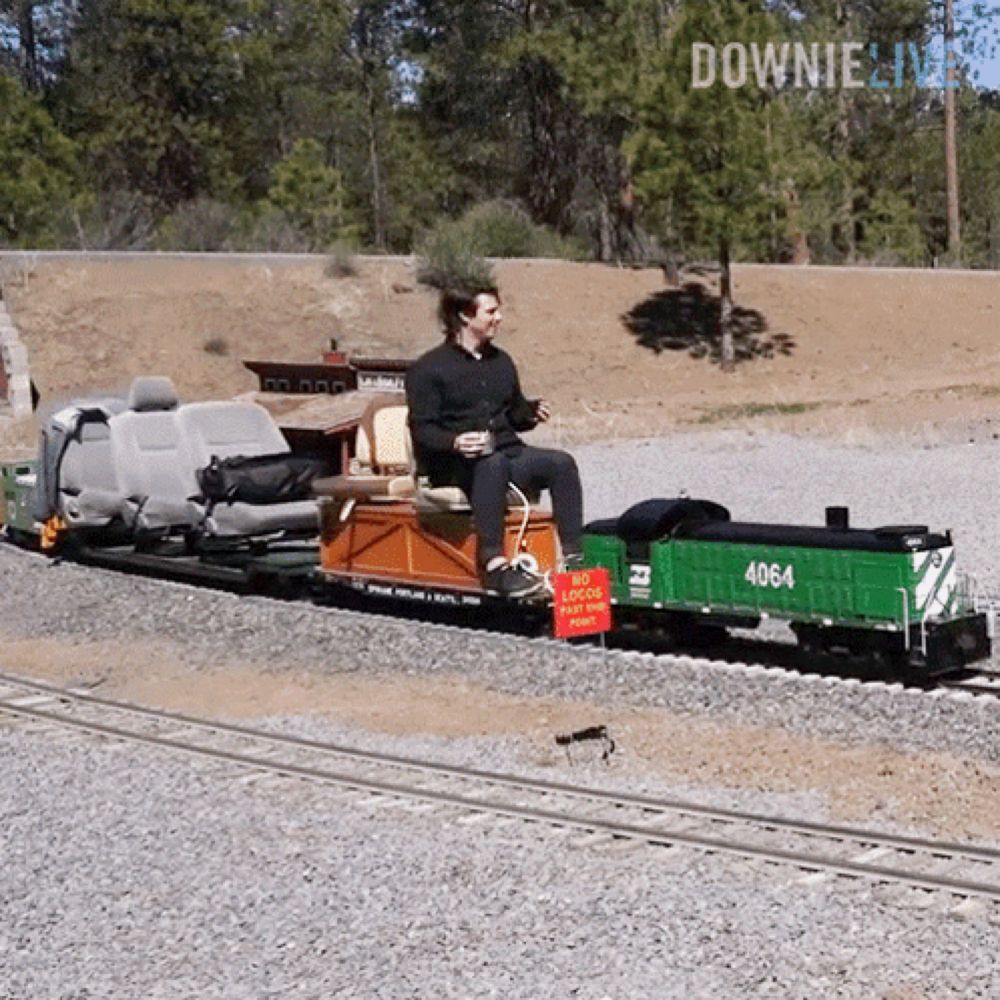 a man sits on the back of a train with 4064 on it