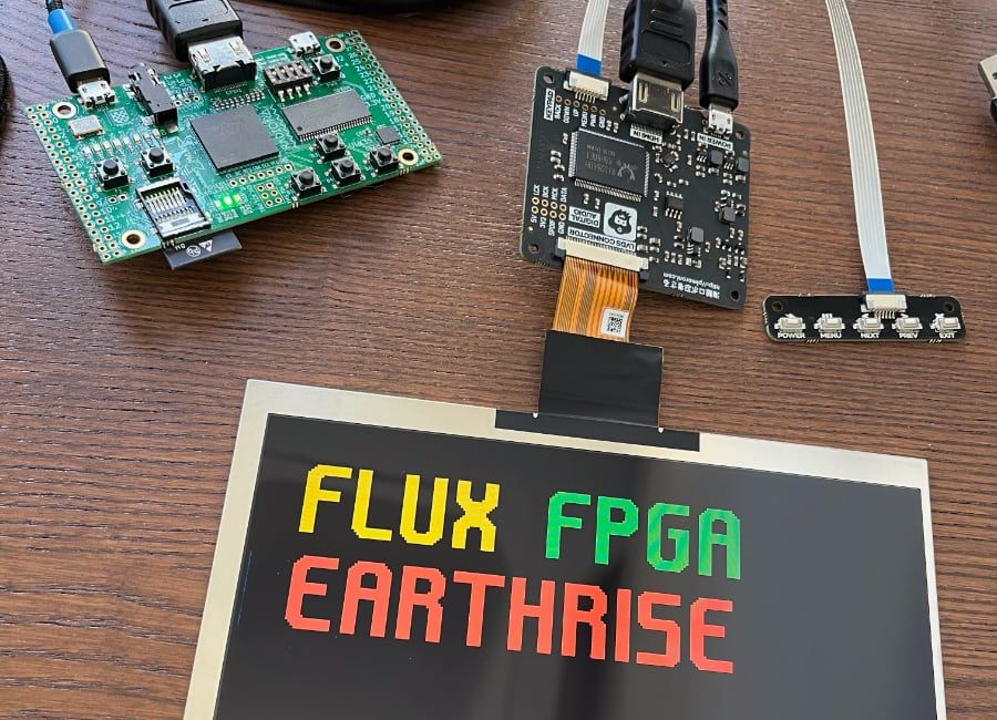 FPGA dev board connected to LCD panel showing the text "FLUX FPGA EARTHRISE" in an angular typeface.