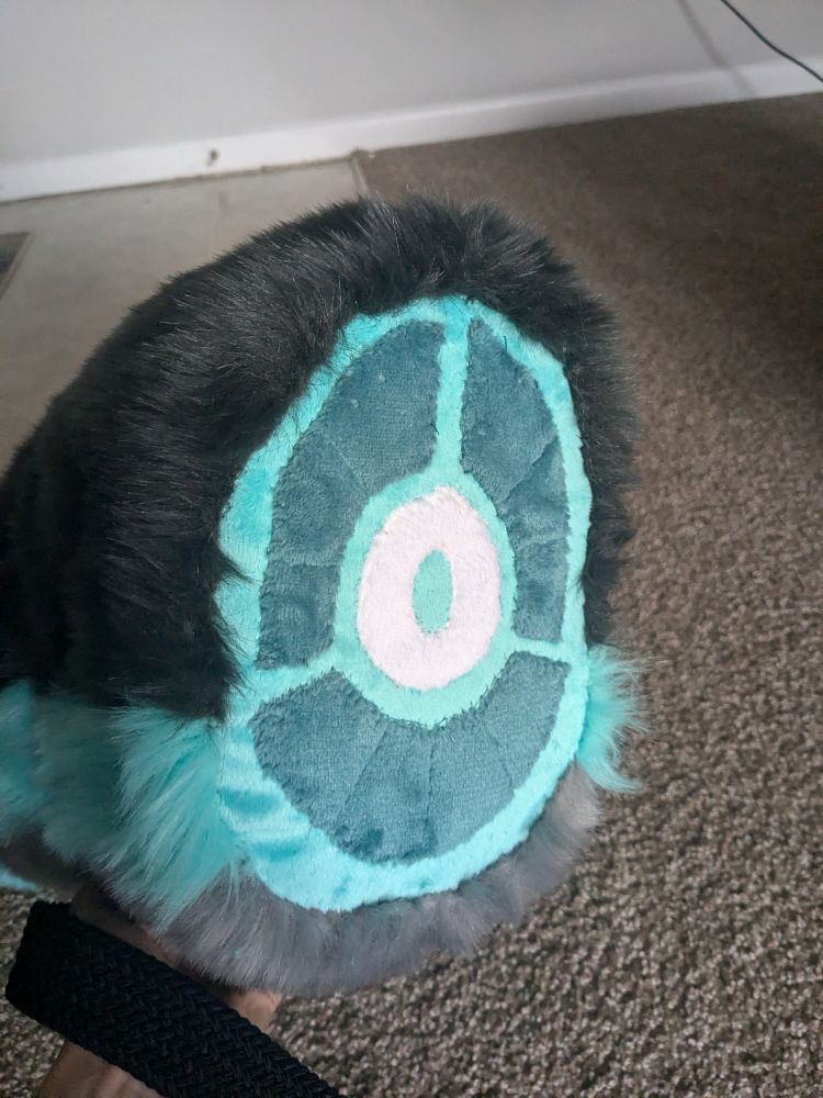 A fursuit tail featuring an end section that resembles meat around a bone