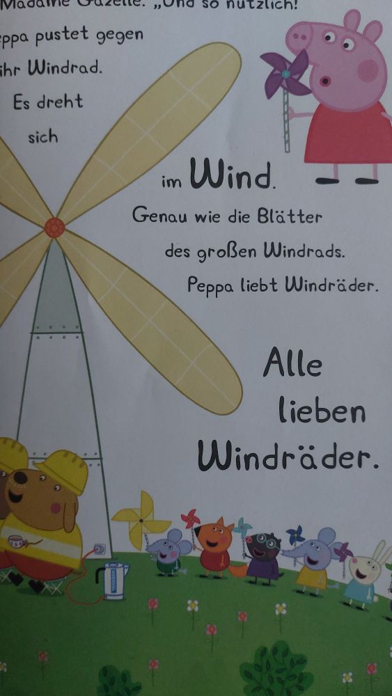 Letzte Seite einer Peppa-Pig/Wutz-Geschichte. Ein großes Windrad ist zu sehen. Daneben Peppa und ihre Freund*innen mit kleinen, selbstgebastelten Windrädern in den Händen. Im Text heißt es: "Peppa pustet gegen ihr Windrad. Es dreht sich im Wind. Genau wie die Blätter des großen Windrads. Peppa liebt Windräder. Alle lieben Windräder."
