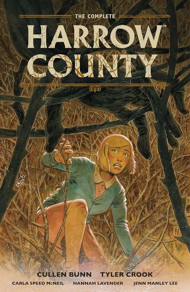 Cover for the complete Harold County featuring Emmy climbing through a thistle bush, and seeing the hand of the skinless boy hanging in the branches