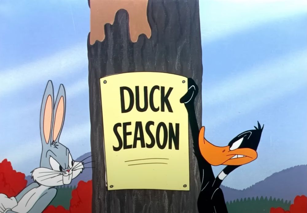 This reveals a new sign that says duck season and now Daffy duck is about to tear it down
