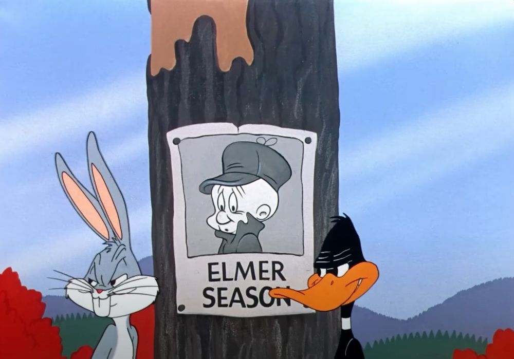 Bugs Bunny and Daffy duck look over at Alma Fudd and smile