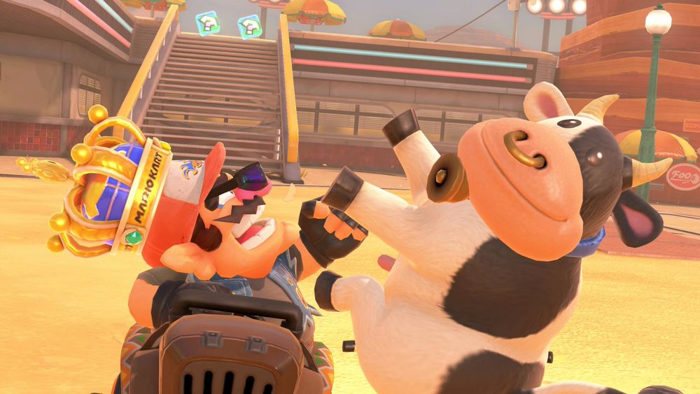 Wario from Mario Kart World punching the Cow from Mario Kart World.