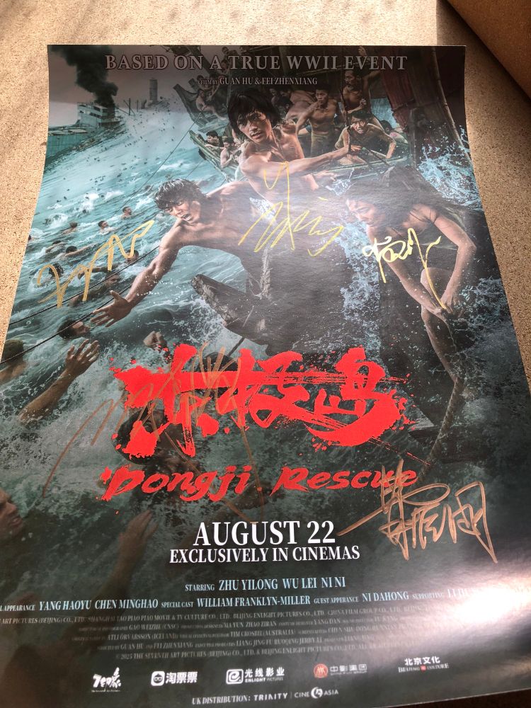 a poster for Dongji Rescue the movie, with signatures from actors and director in gold ink