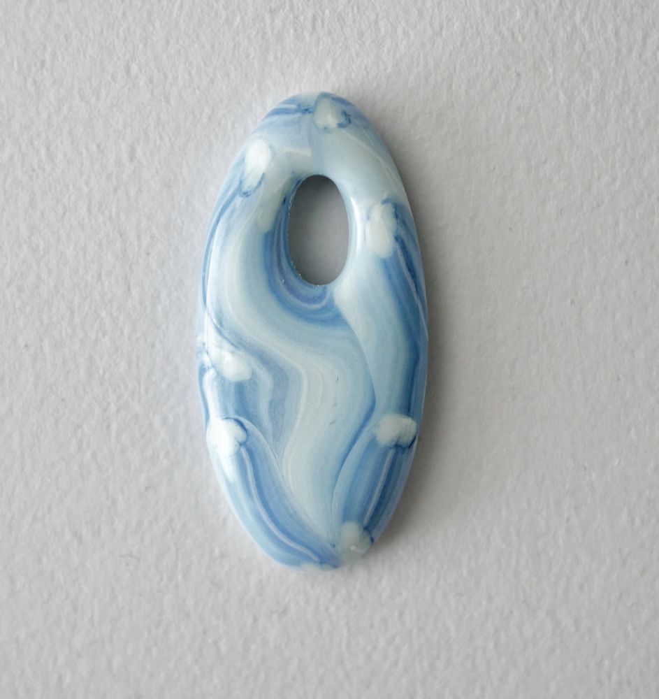 white and blue pendant in a brushstroke pattern. it's the exact color of extremely worn light color jeans