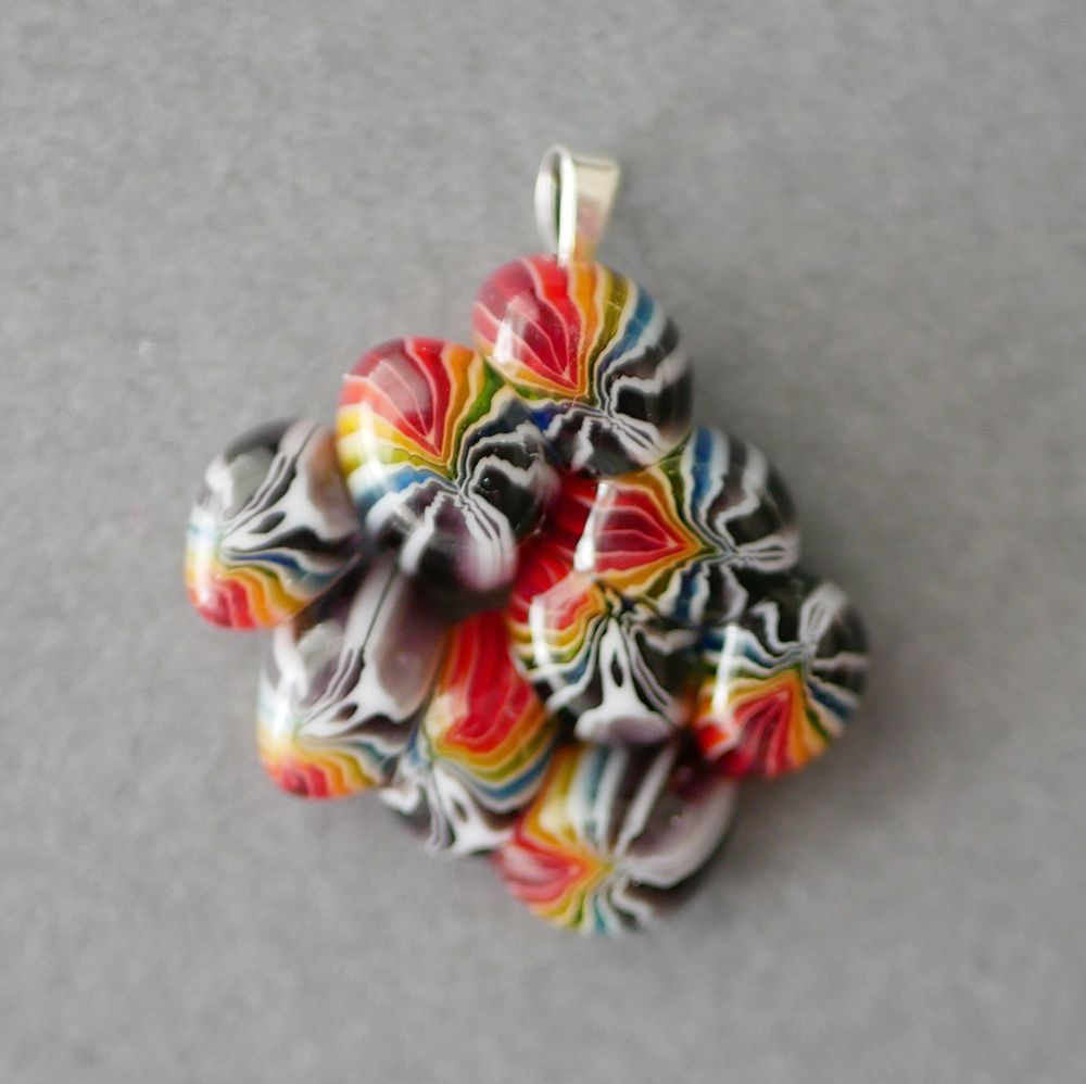 rainbow blob pendant that looks like a cluster of rainbow tubes desperately escaping something 
