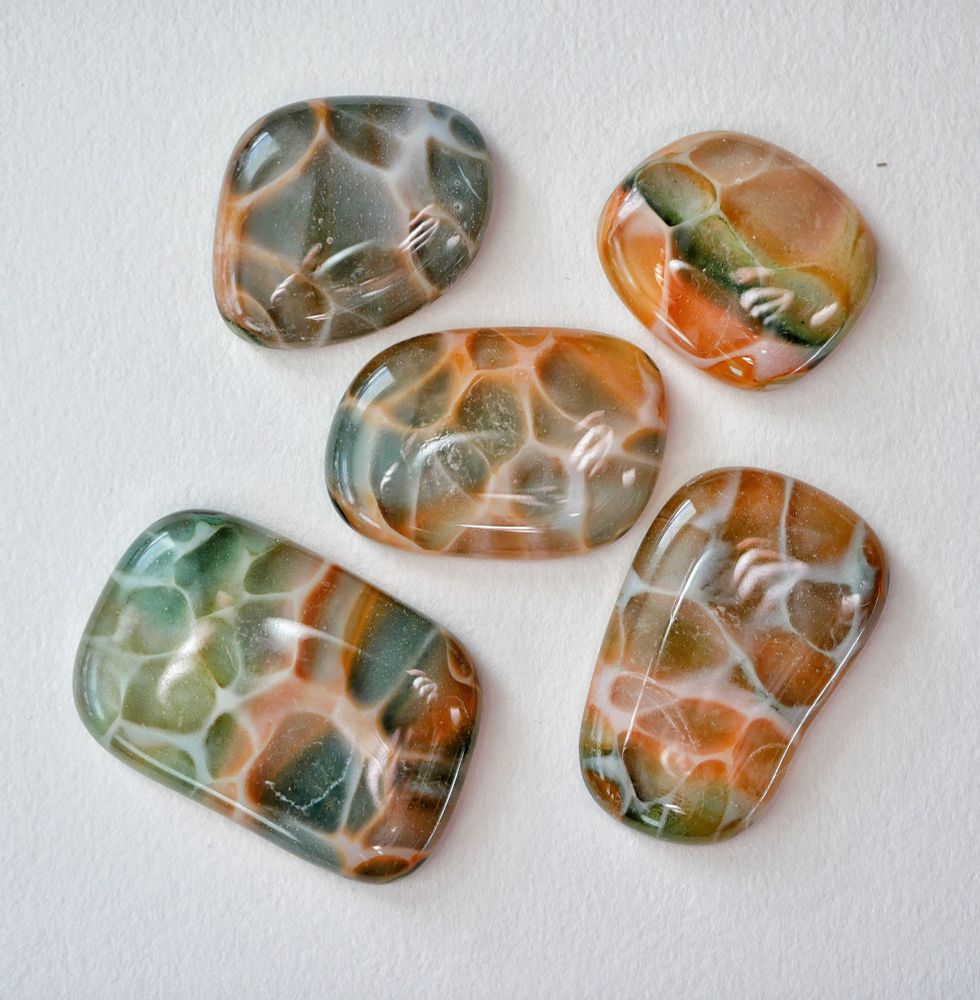 5 green and orange dragonskin cabochons in freeform organic shapes with the signature white pattern on top where the color forms cells that have white around the edges