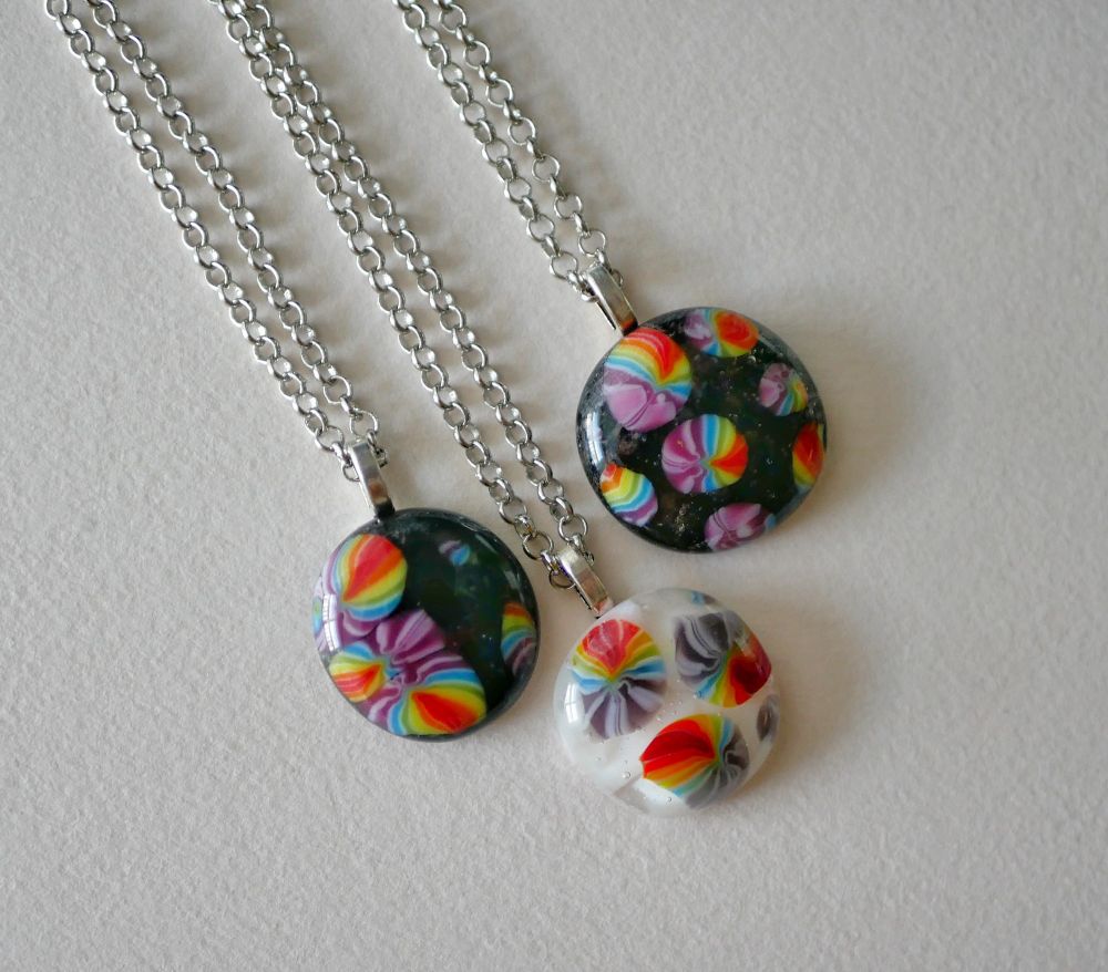 pendants with rainbow foregrounds and black and white backgrounds 
