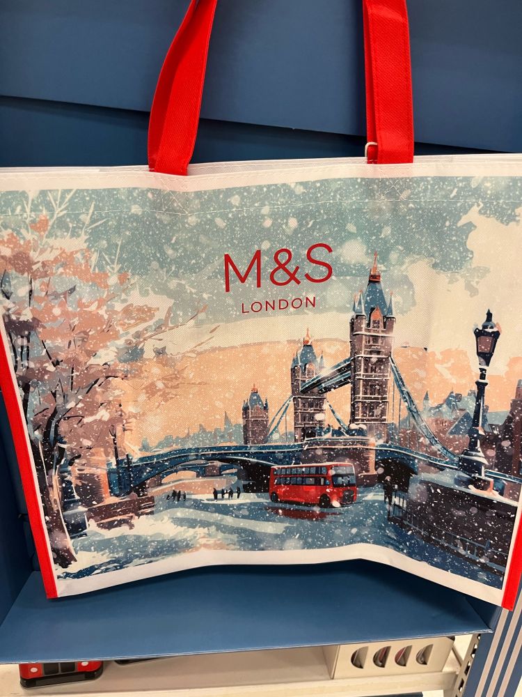 A reusable shopping bag with a nonsensical illustration of Tower Bridge and the riverside in the snow.