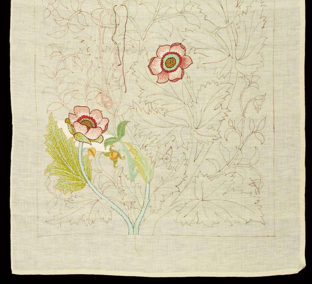 A panel of cream-colored cotton with an outlined design of intertwining stems, leaves, and anemone flowers drawn on. A small portion of the design has been stitched in silk threads: a blue-green stem, one large yellow-green serrated leaf, a few smaller leaves in various shades of green, two small orange buds, and two mid-sized anemone blooms in shaded pink. A small portion of the background is also stitched, in white.
