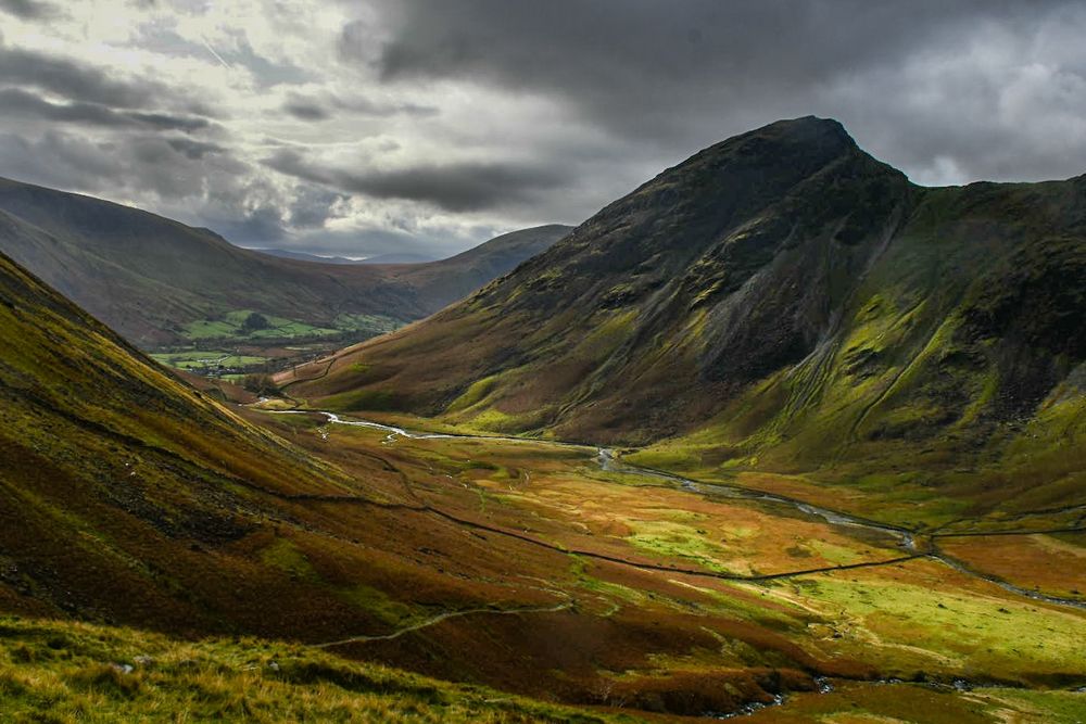 Light hits the valley floor and the craggy side of Yewbarrow in the Lake District.