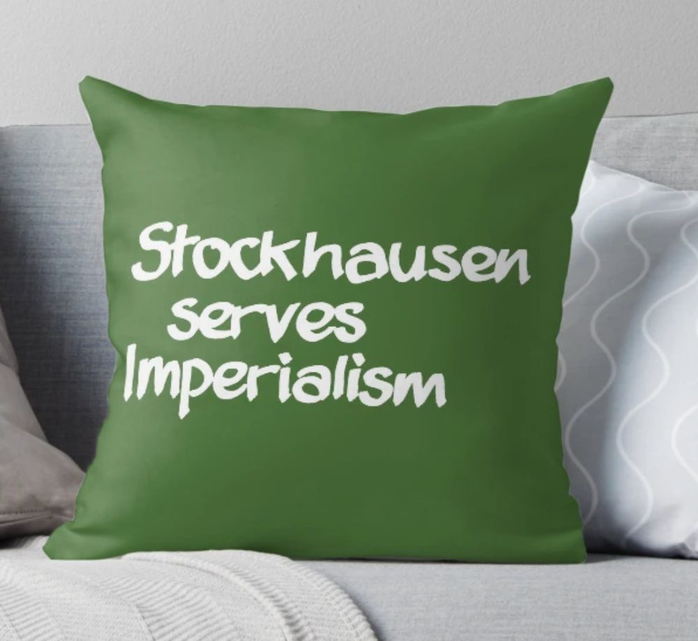 A green show cushion with the words 'Stockhausen serves Capitalism' printed on it
