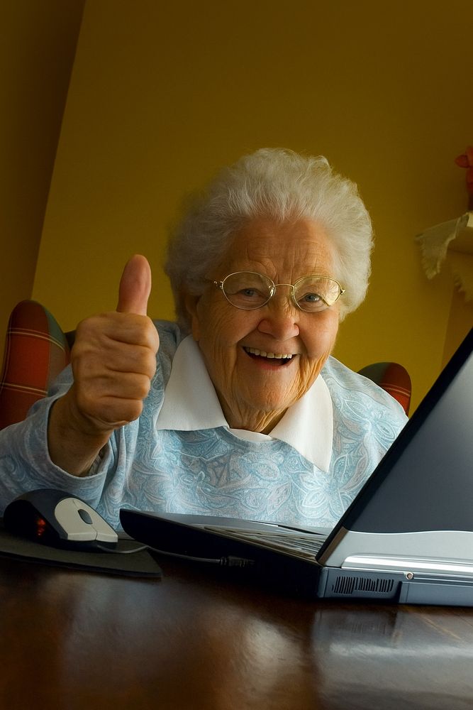“Grandma Finds The Internet” smiling at the camera with a thumbs up. Generated by AI.