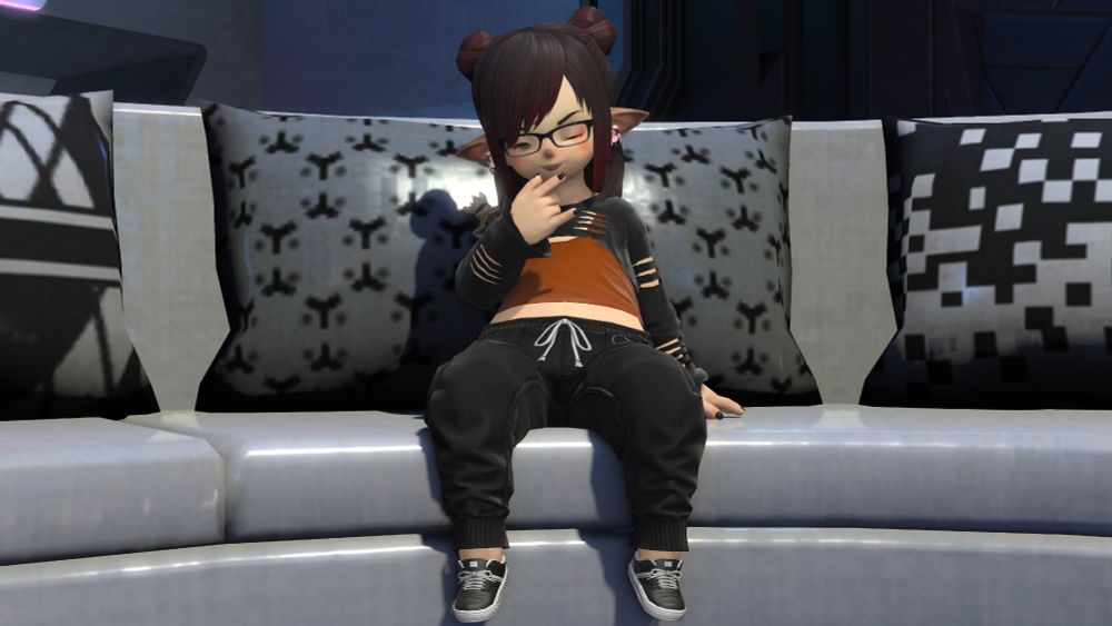 Cinna Bunns, Lalafell, snarky femboy, clothed in black sweatpants and a cinnamon brown-coloured undershirt, with a modified/cropped sweater, sitting on a curved couch in Solution 9 adorned with various comfy throw pillows, his legs rest against the face of the couch, on arm beside him, the other held up to his chin, as well as one eye winking and his tongue sticking out to do a pseudo "rizz" face ~