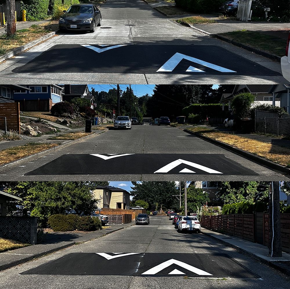 Three speed humps, pictured from the street.