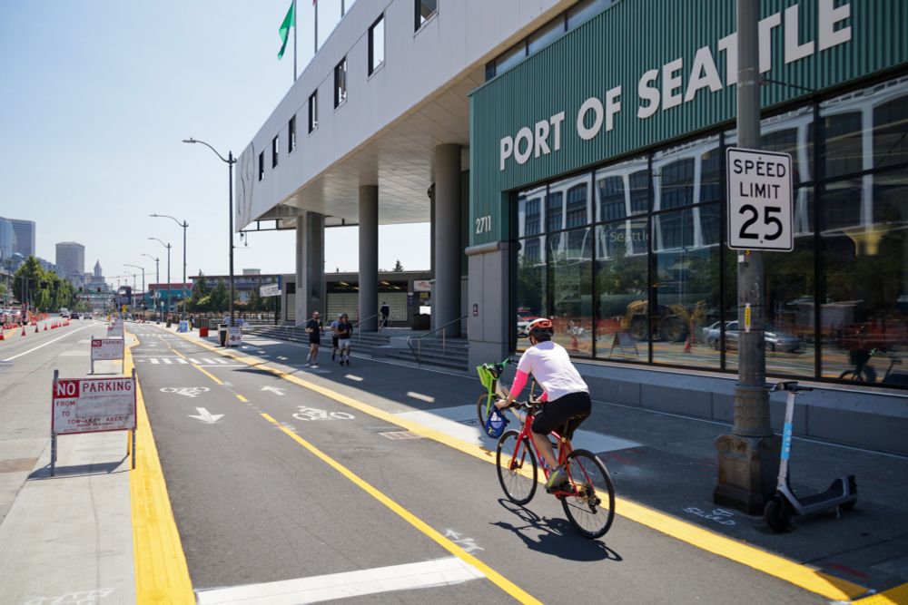 A person rides a bike in the protected bike lanes near the Port of Seattle.
