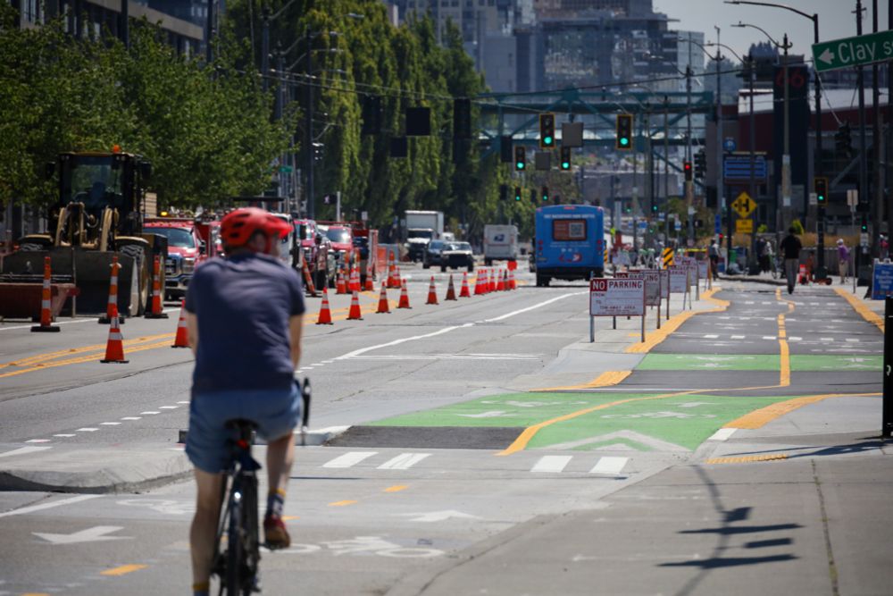 A person rides a bike in the protected bike lane along Alaskan Way.