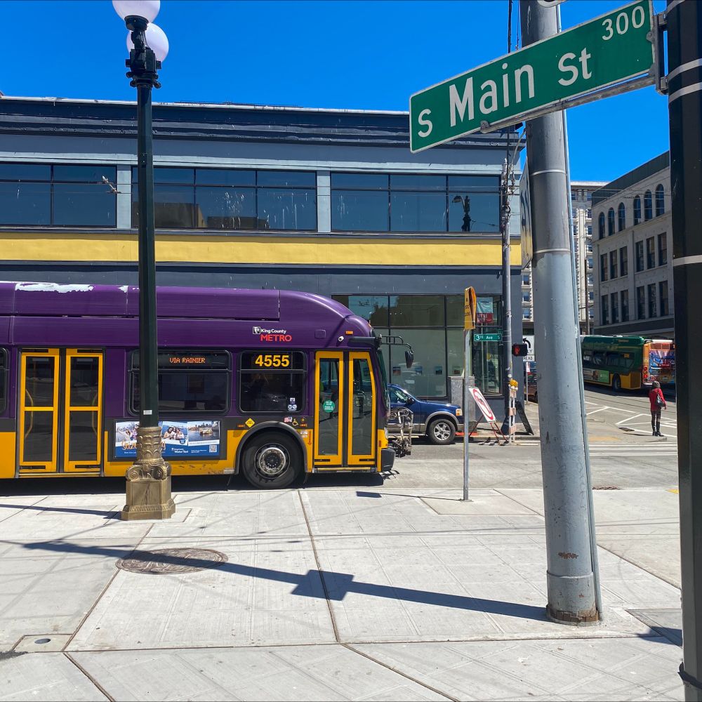 A bus at 3rd Ave and S Main St in downtown Seattle near Pioneer Square, showcasing a wider sidewalk.