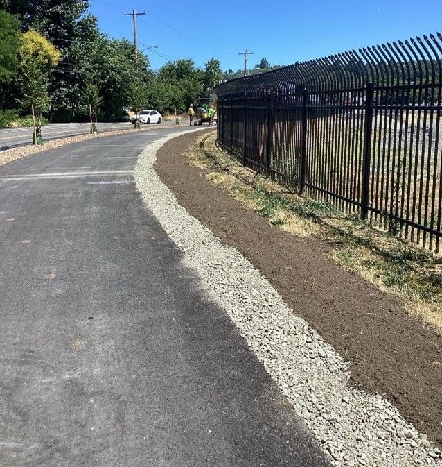 Landscaping underway next to the new multi-use path on S Albro Pl.