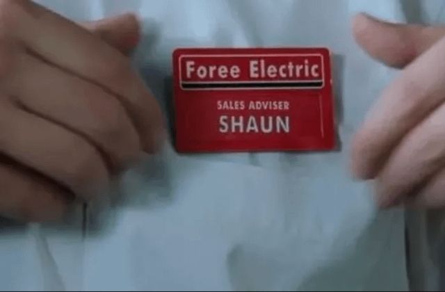 Shaun adjusts a red name tag on his white shirt. The tag is headed "Foree Electric"