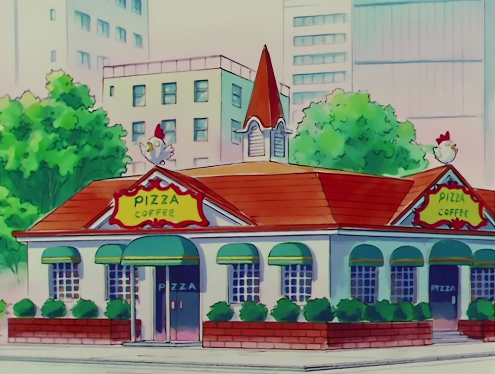 An establishing shot from SAILOR MOON R, featuring a restaurant apparently named "Pizza Coffee" with a wild-eyed chicken as a mascot.