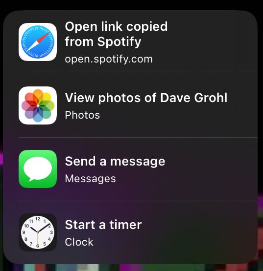 Suggested activities on an i-Pad. In order:
“Open link copied from Spotify”
“View photos of Dave Grohl”
“Send a message”
“Start a timer”