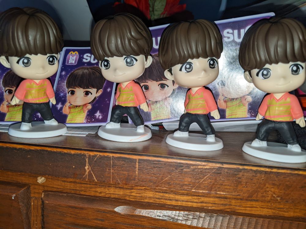 A photograph of 4 Suga figures from McDonald's Happy Meals