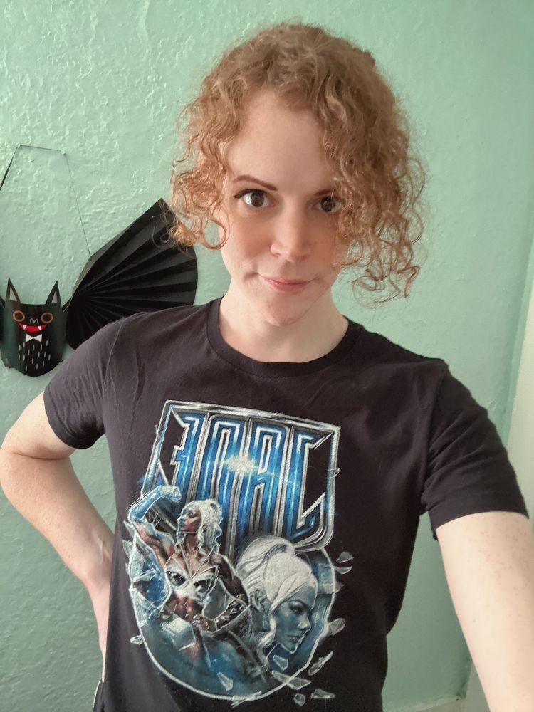 Selfie of Vivian smiling slightly with minimal makeup and a Jade Cargill t-shirt