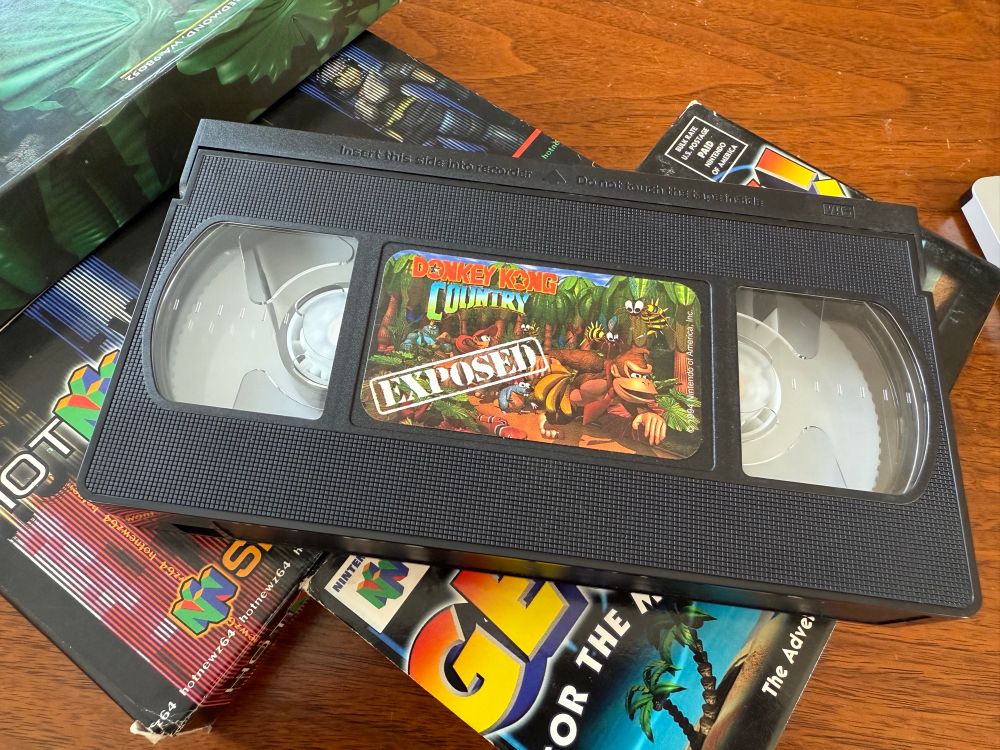 Three VHS cassettes promoting 1990s Nintendo game releases.