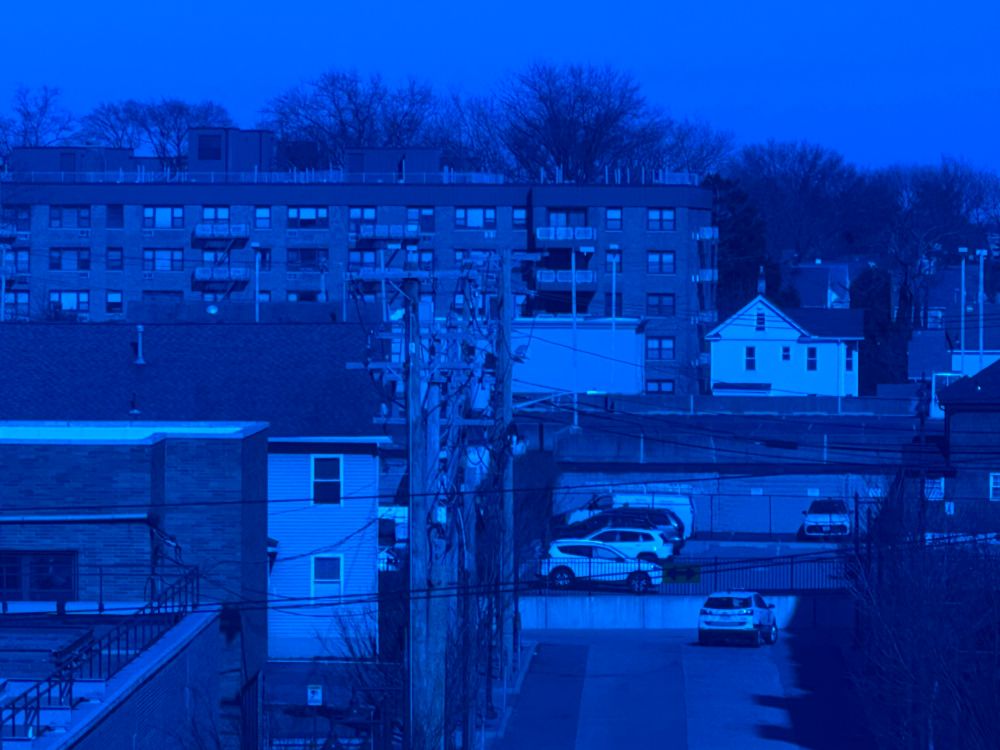 Blue tinted brick buildings, houses, and cars