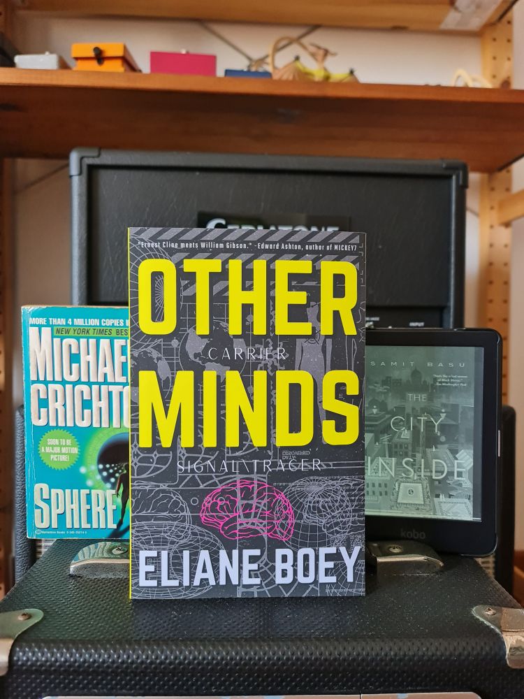 Three books on two amps. Foreground: Other Minds by Boey. Background: Sphere by Michael Crichton, and The City Inside by Samit Basu. My physical copy of TCI is elsewhere!