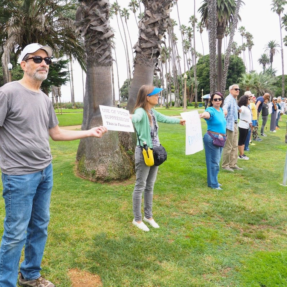 Protesters join hands to form the chain. 