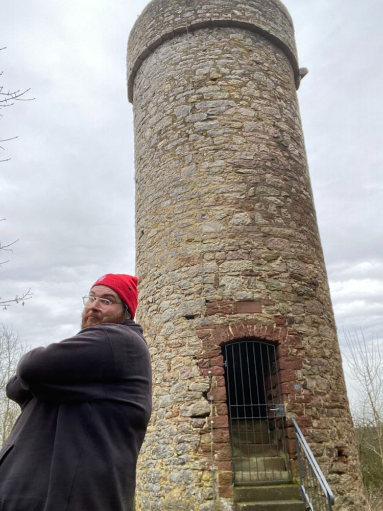 Me posing in front of a Tower in the middle of the forest