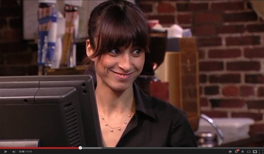 A girl GRINNING with an air of absolute chaos and mischief.