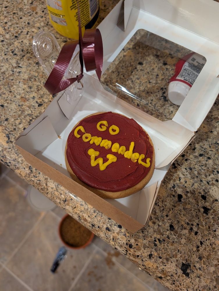 A wegman's sugar cook with "Go Commanders" in gold on a burgundy background sitting on my kitchen counter.