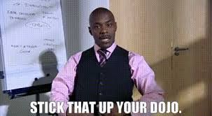 Paterson Joseph as Alan Johnson in S4 E2 of Peep Show ('Conference'), wearing a pink shirt and black waistcoat.

Caption 

STICK THAT UP YOUR DOJO.