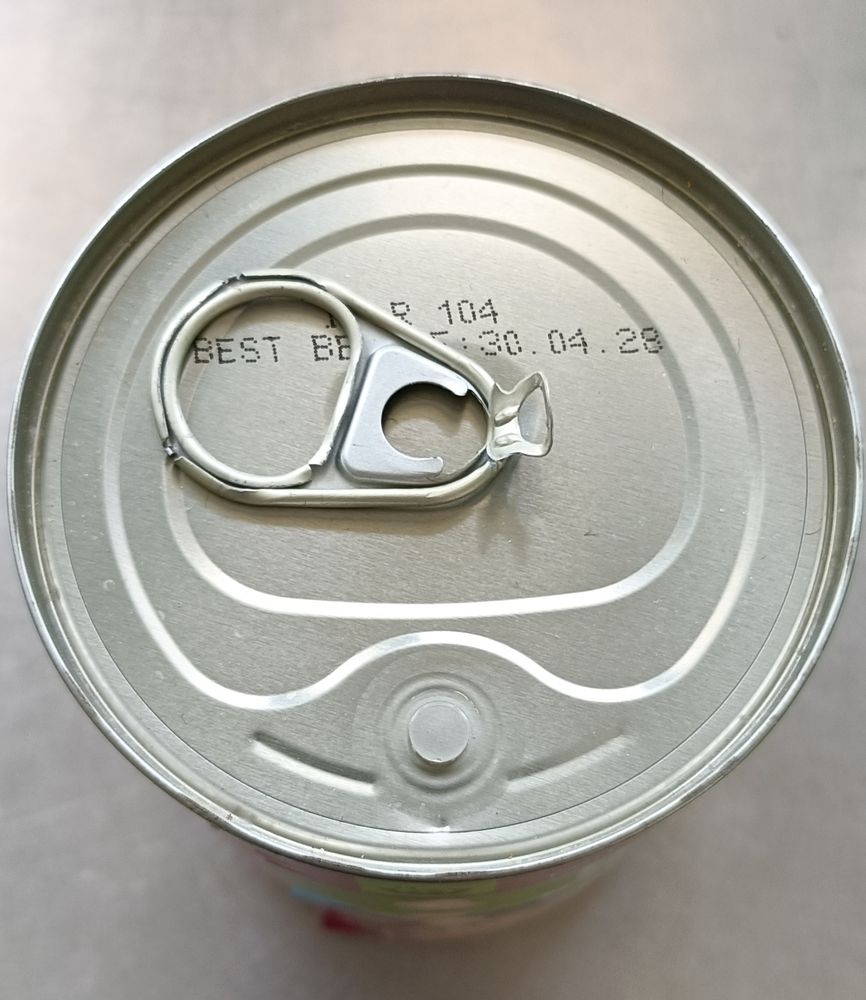 The top of a ring-pull can. The ring is now detached, but the can is not open. 