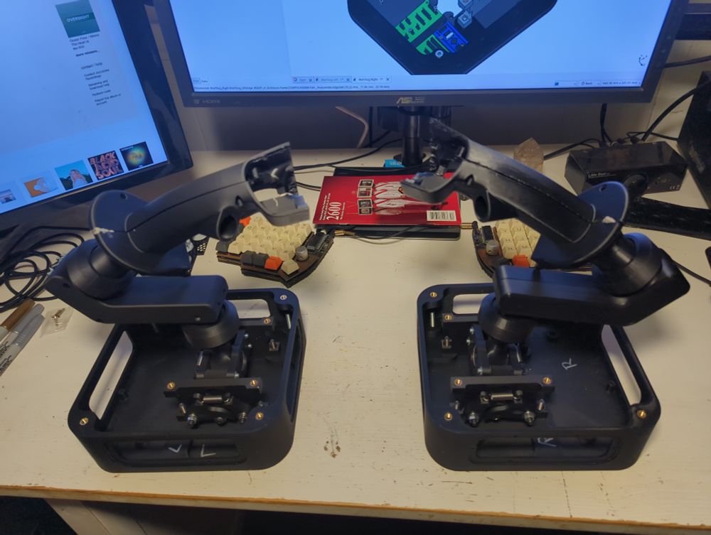 Two partially constructed, skeletal joysticks
