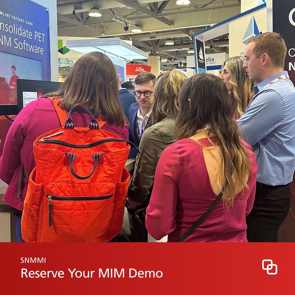People gathered around a computer demoing MIM at a trade show. 