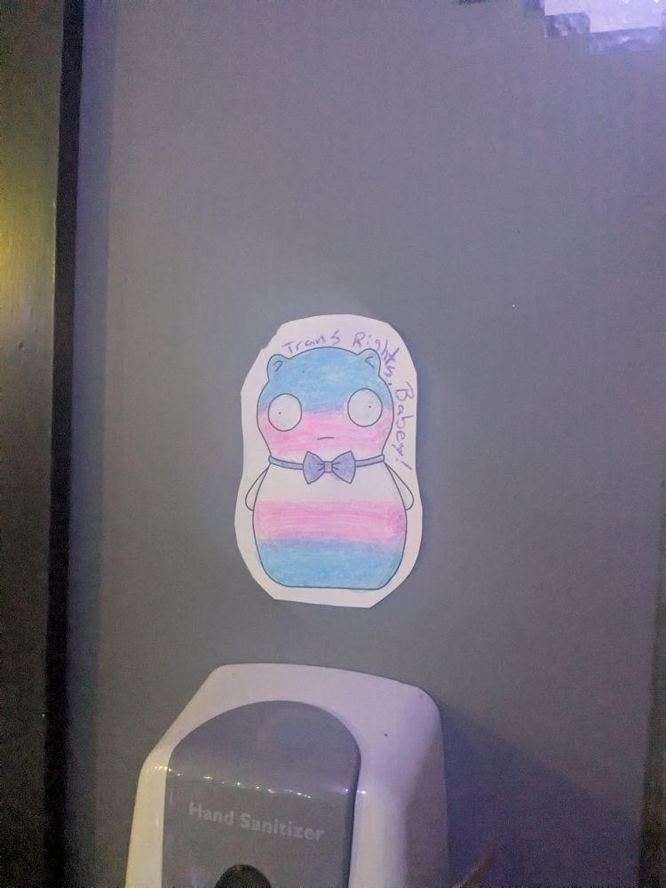 Dapper Kuchi Kopi colored with trans pride colors. Text reads "Trans Rights Babey!"