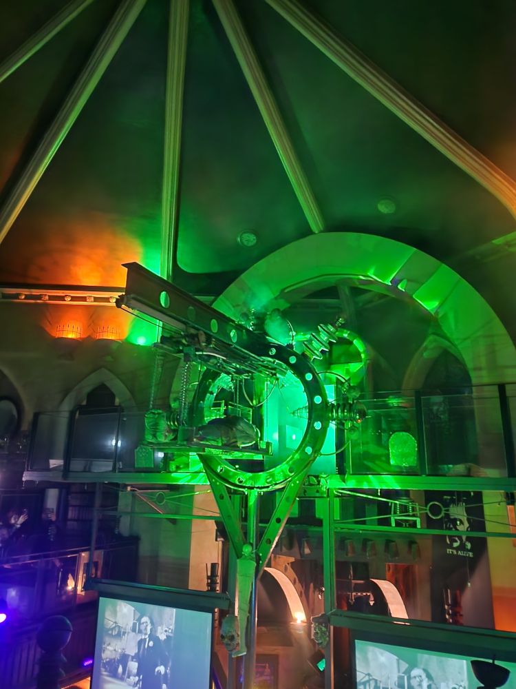 frankenstein's monster animatronic being lowered with lots of green lighting