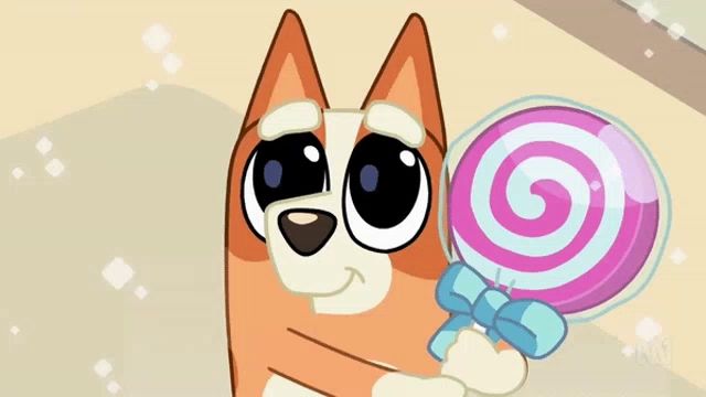 a cartoon dog is holding a pink lollipop with a blue bow