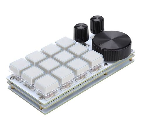 A white macro pad with 12 blank buttons in white on the left, two small black knobs in the top right, and one extra large black knob in the bottom right.