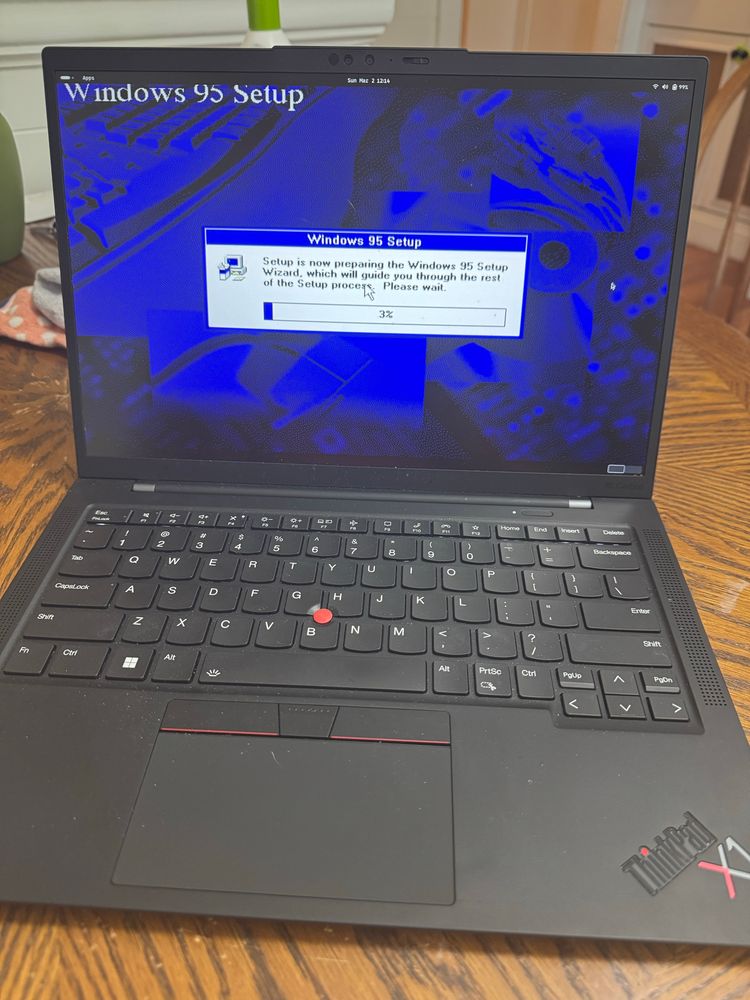 Thinkpad X1 laptop with the background image as the setup and install screen from Windows 95. Everyone of a certain age will remember the excitement that was transitioning from Windows 3.1 to Windows 95